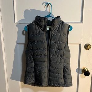 A cozy and puffy vest with a detachable hood.